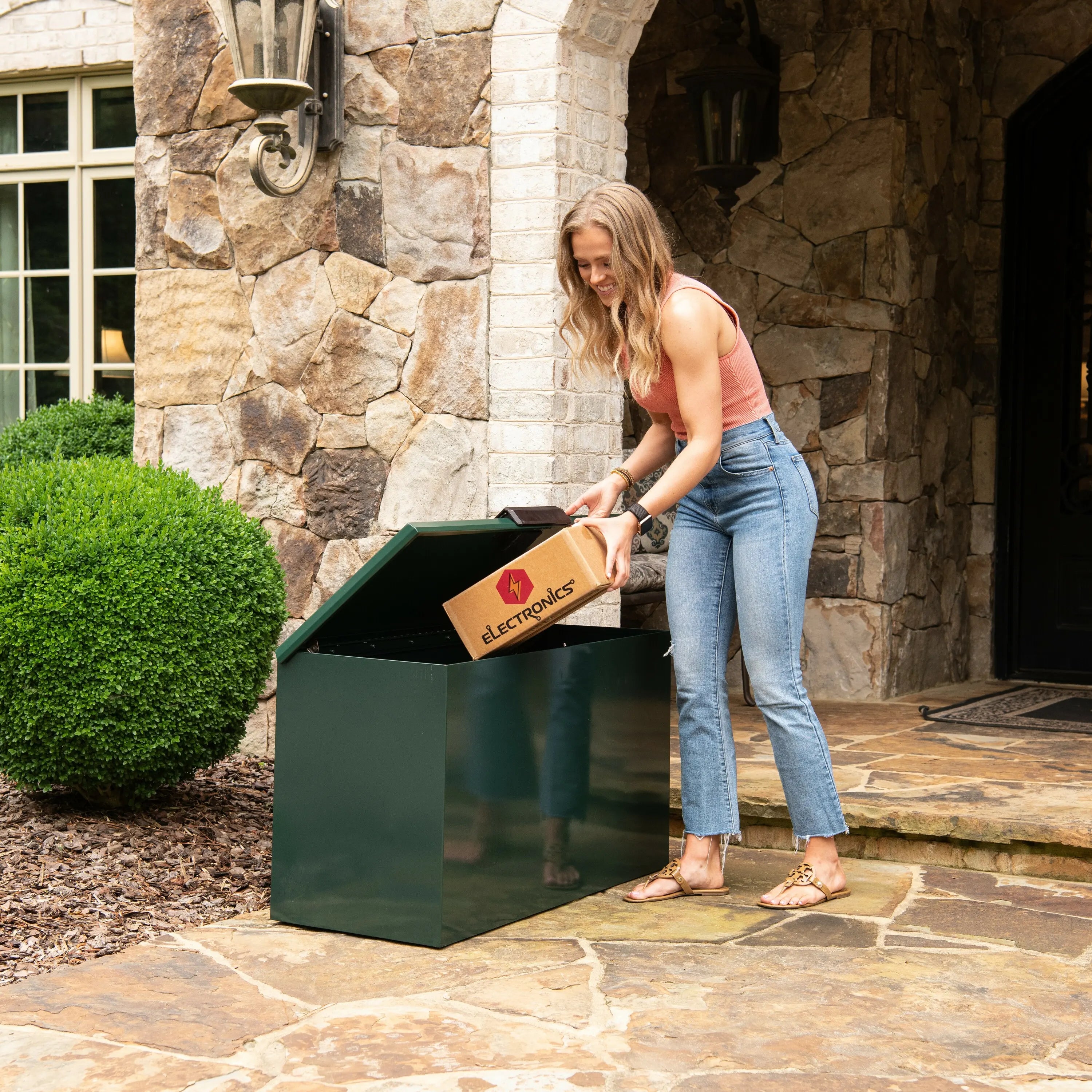 Homeowner retrieving package from Loxx Boxx X-Large Spruce.