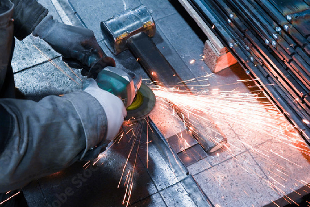 picture of a worker using an electrical circular saw to shave down steel