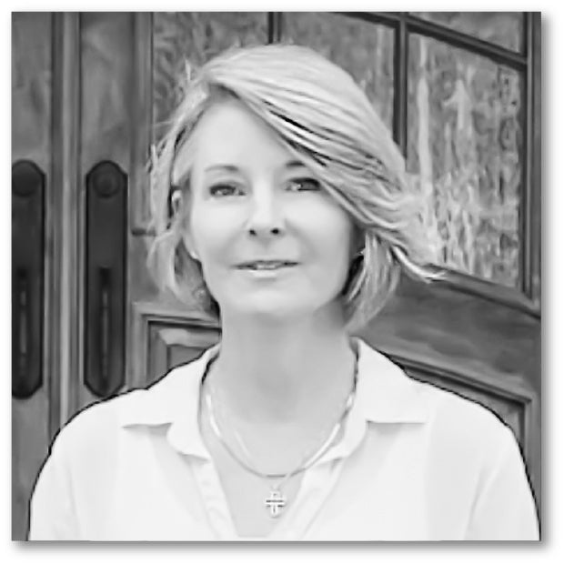 Black and white photo of a woman with blonde hair wearing a white shirt.