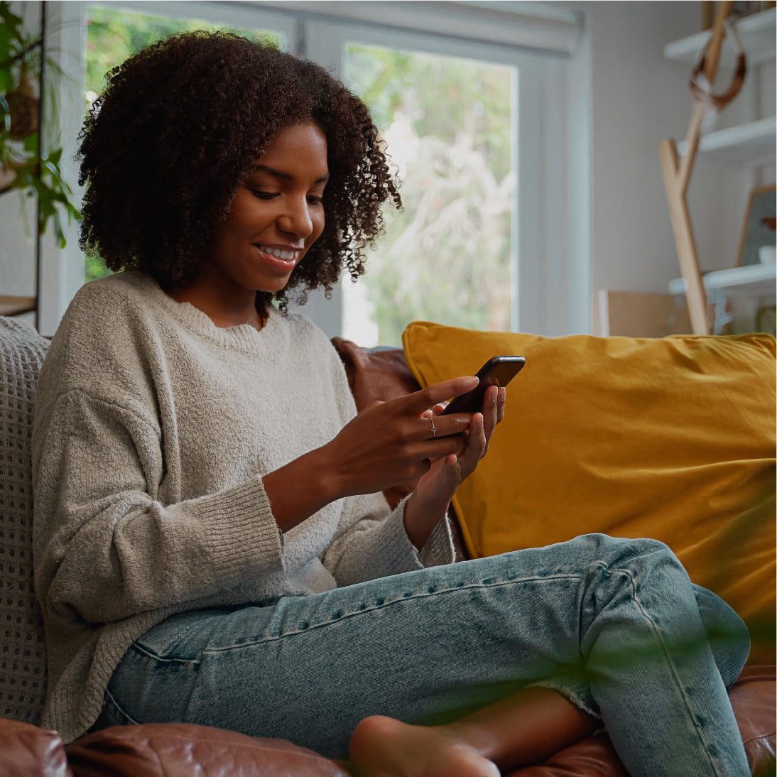 loxxboxx app is being used while woman is sitting in living room couch