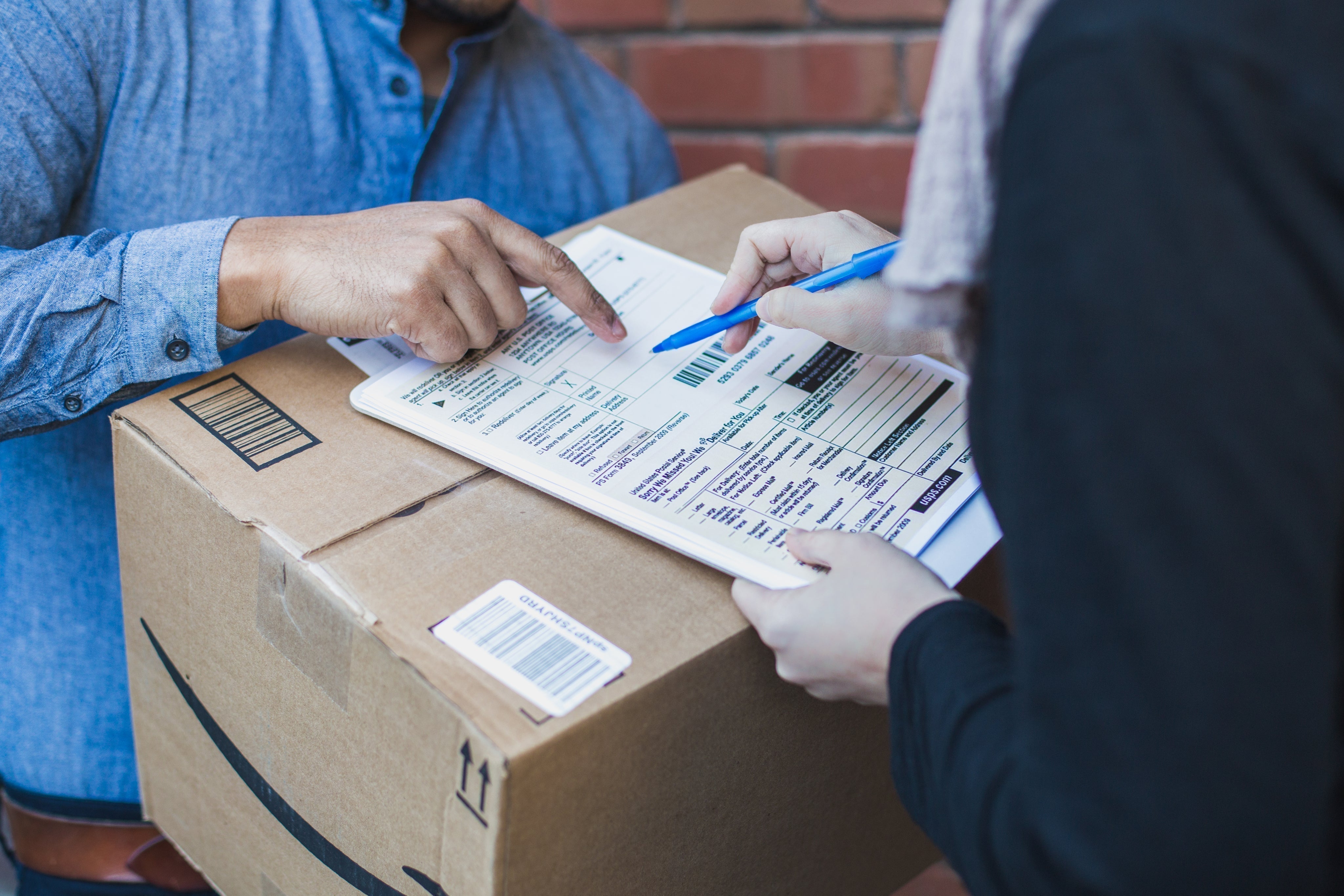 Package delivery carrier making homeowner sign for package