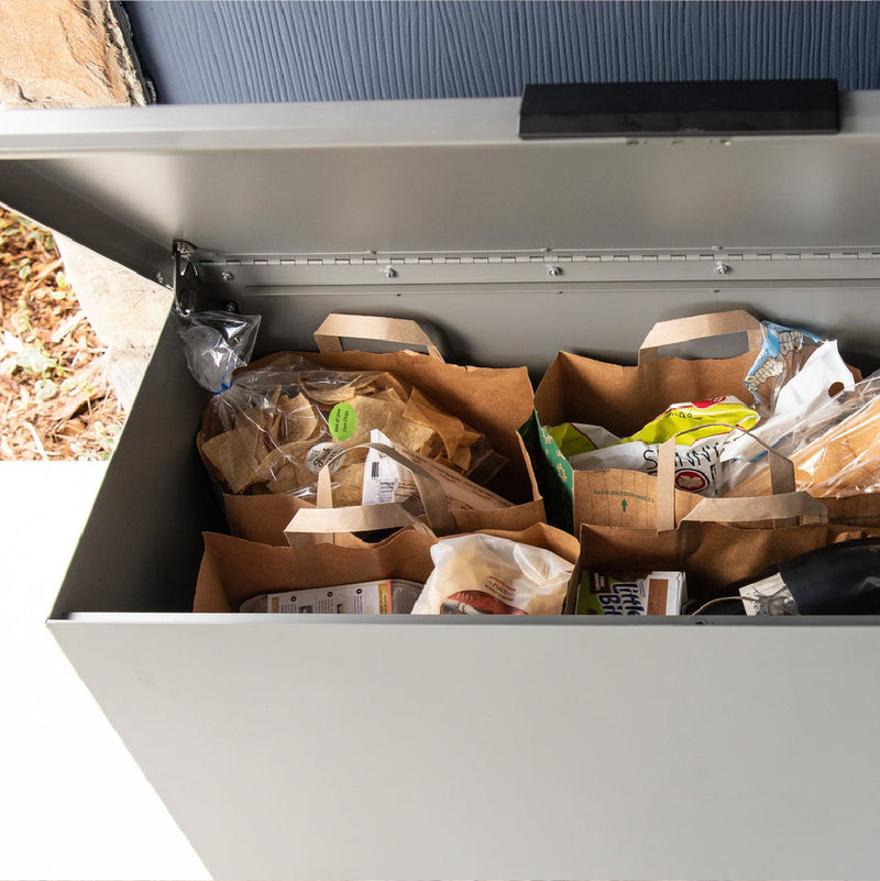 picture of a gray loxxboxx that has been opened to reveal bags of groceries sitting inside