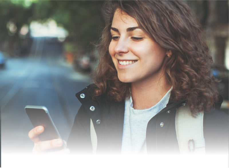 delivering a special gift, woman smiles down at phone knowing her package will reach its destination safe and sound